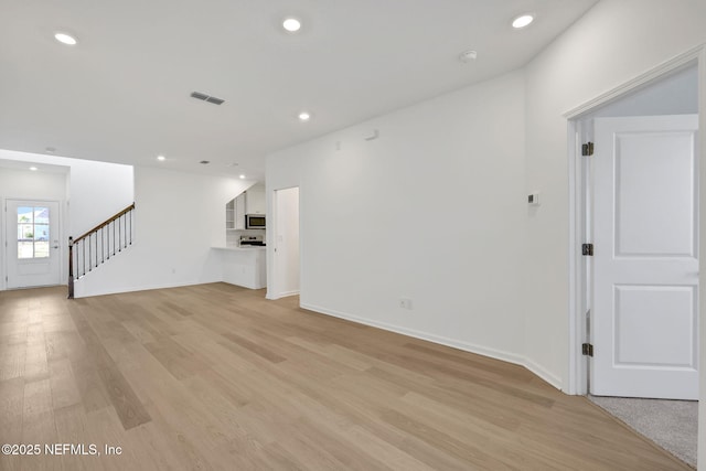 unfurnished living room with light wood-type flooring