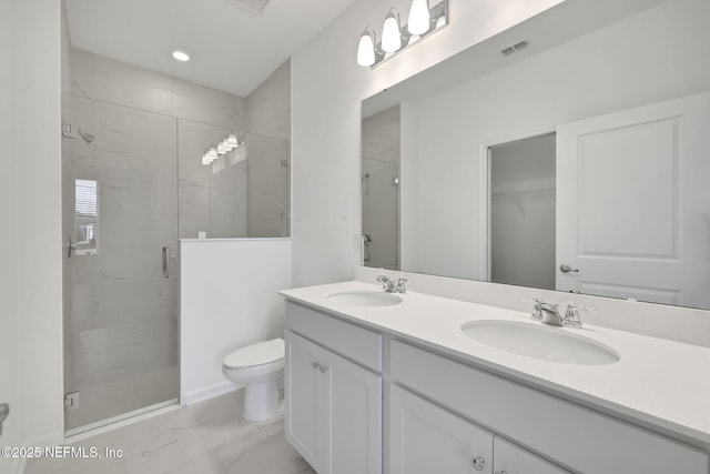 bathroom featuring vanity, an enclosed shower, and toilet