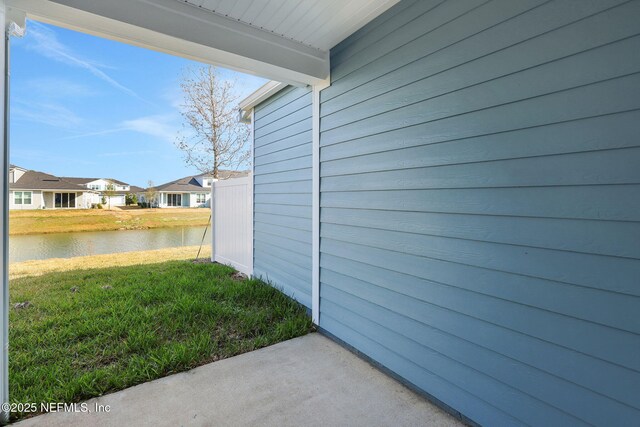 exterior space with a water view and a lawn