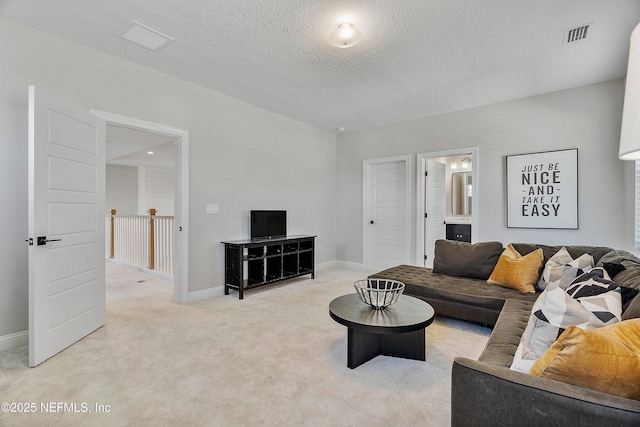 carpeted living room with a textured ceiling