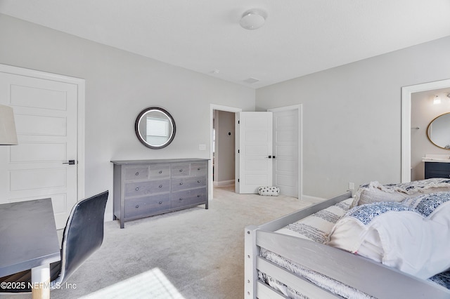 bedroom with light carpet and ensuite bathroom