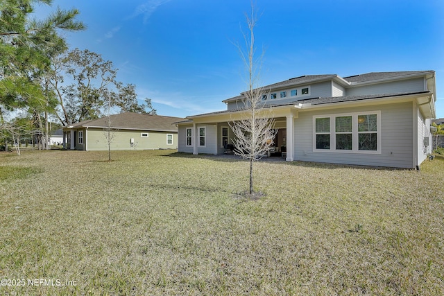 rear view of property with a yard