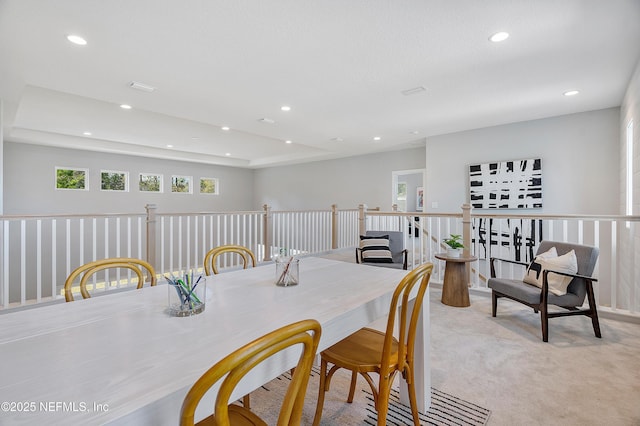 carpeted dining area with plenty of natural light