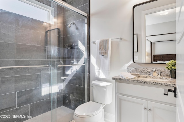 bathroom featuring walk in shower, vanity, and toilet