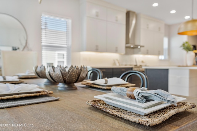 interior details featuring wall chimney range hood