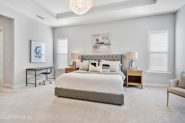 bedroom with an inviting chandelier, crown molding, light colored carpet, and a raised ceiling