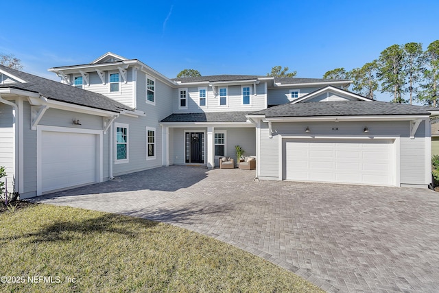 view of front of home with a garage and a front lawn