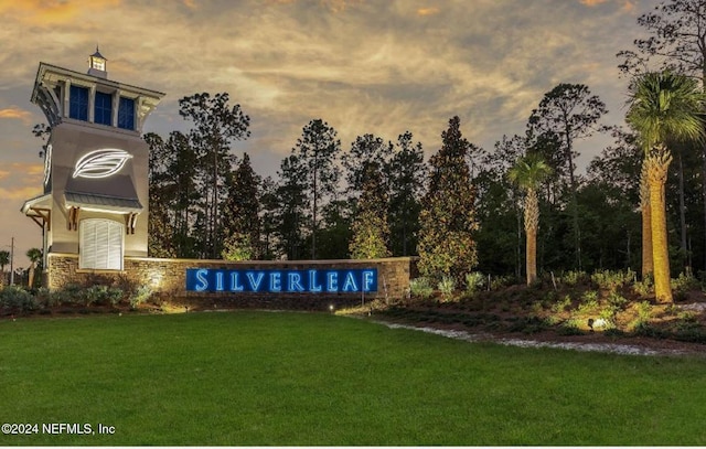 community / neighborhood sign with a lawn