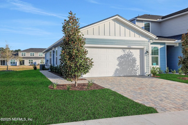 view of front of house with a garage and a front yard