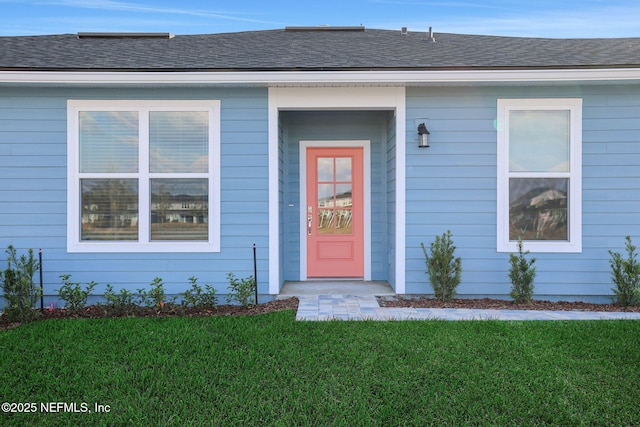 entrance to property with a lawn