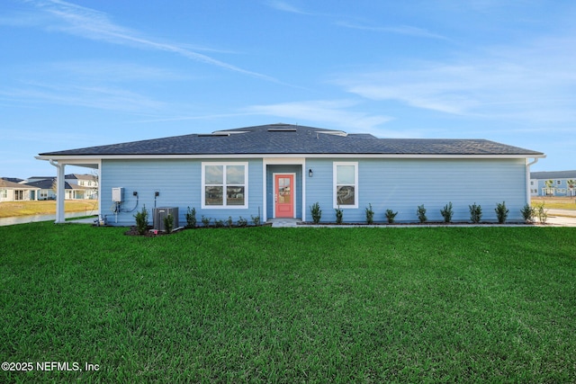 ranch-style house featuring central AC unit and a front yard