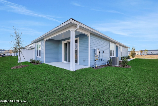 back of property featuring a patio, central AC unit, and a lawn