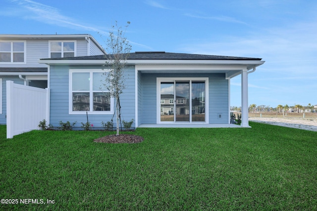 rear view of house with a yard