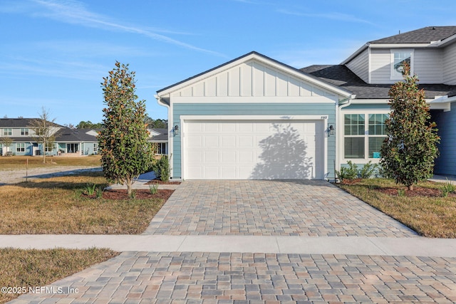 view of front of house with a garage and a front lawn