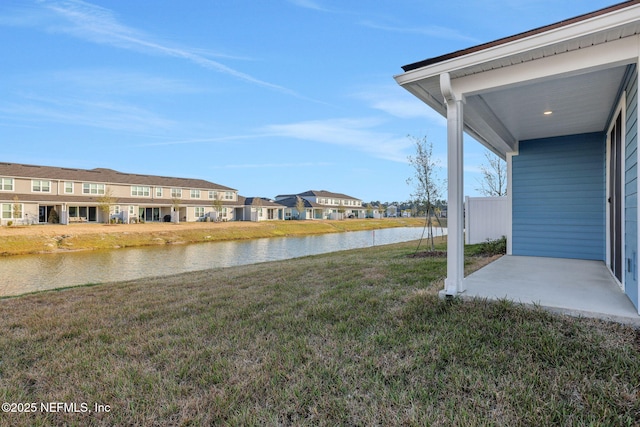 view of yard featuring a patio and a water view