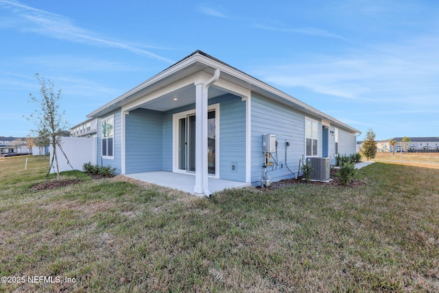 back of house with a lawn, cooling unit, and a patio area