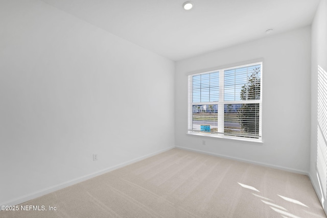 empty room featuring light carpet