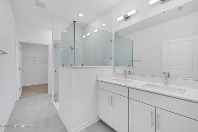 bathroom with vanity and a shower with door