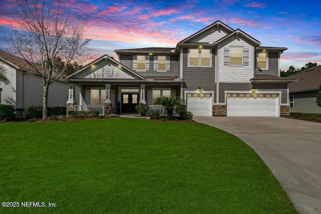 craftsman inspired home featuring a garage, driveway, a porch, and a front lawn