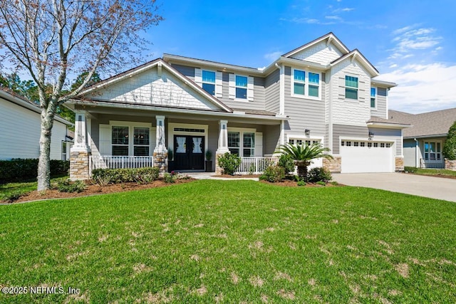 craftsman house with a front yard, a porch, concrete driveway, a garage, and stone siding