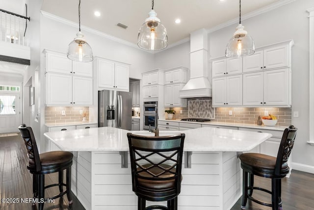 kitchen with dark wood finished floors, visible vents, appliances with stainless steel finishes, and custom range hood