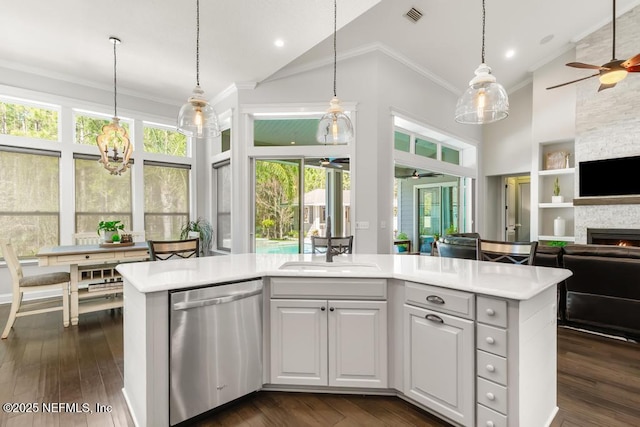 kitchen with visible vents, open floor plan, dishwasher, light countertops, and high vaulted ceiling