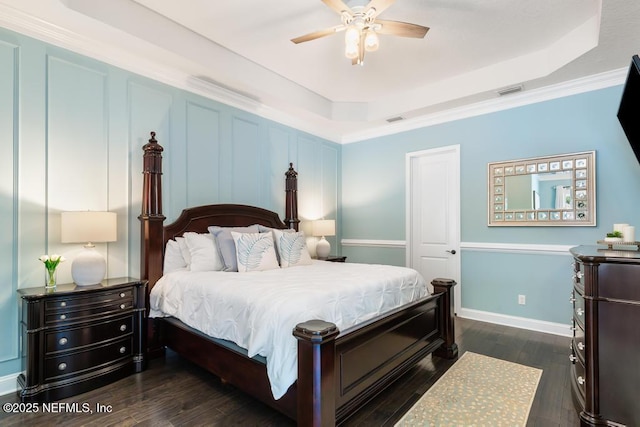 bedroom with a raised ceiling, baseboards, visible vents, and dark wood-type flooring