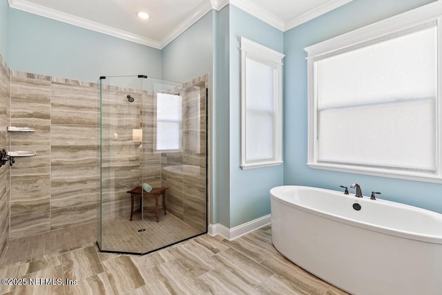 full bathroom with crown molding, a freestanding tub, baseboards, and walk in shower