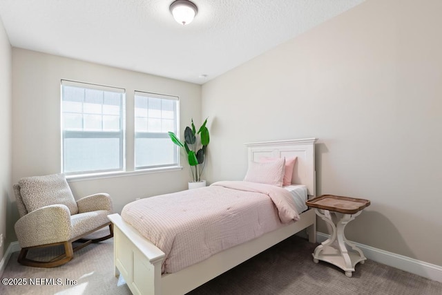 carpeted bedroom with baseboards and a textured ceiling