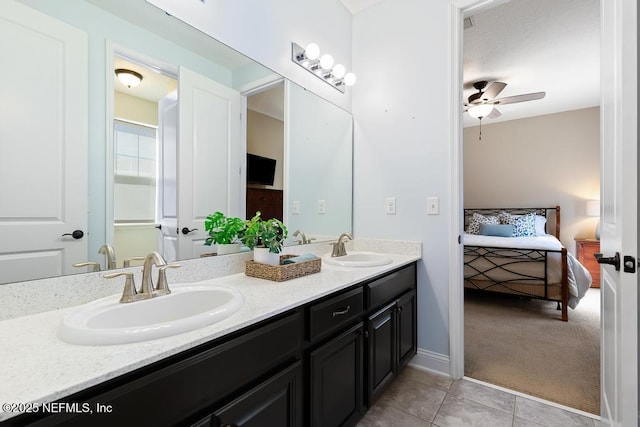 ensuite bathroom featuring a sink, connected bathroom, double vanity, and a ceiling fan