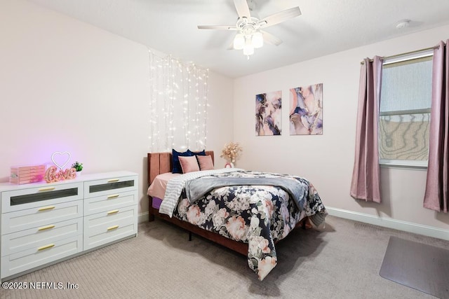 bedroom featuring a ceiling fan, light colored carpet, and baseboards