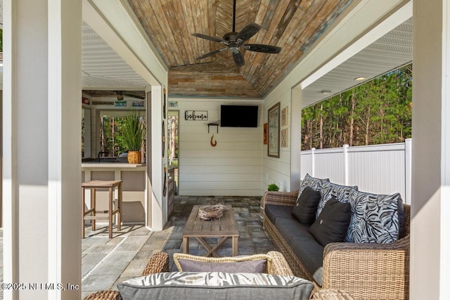 view of patio with outdoor lounge area, ceiling fan, and fence