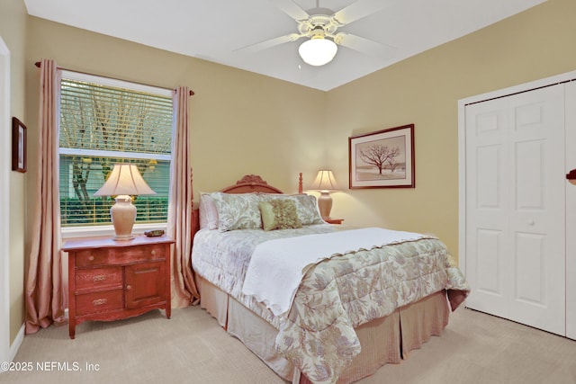 carpeted bedroom with a closet, ceiling fan, and multiple windows