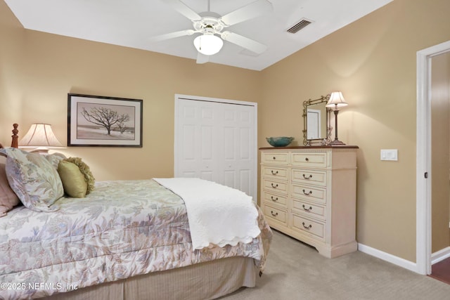 bedroom featuring ceiling fan, a closet, and light carpet