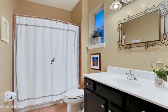 bathroom with toilet, vanity, and a shower with curtain