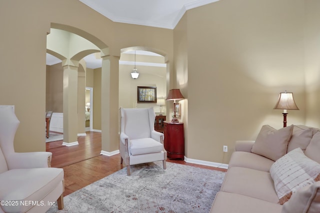 living room featuring crown molding and light hardwood / wood-style floors