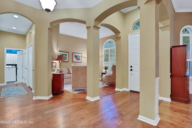 foyer entrance with hardwood / wood-style flooring and ornamental molding