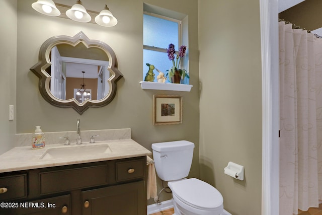 bathroom featuring toilet and vanity