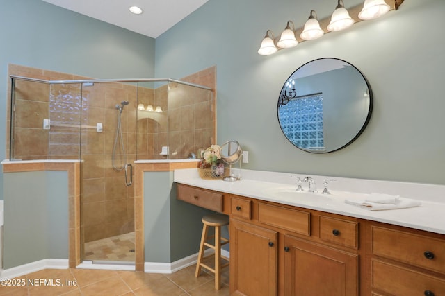 bathroom with vanity, a shower with door, and tile patterned flooring