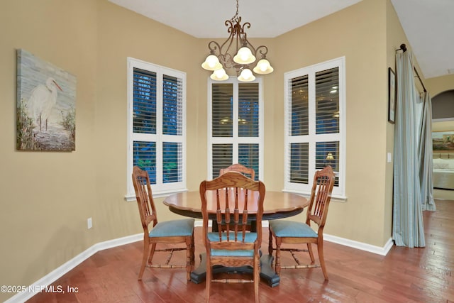 dining room featuring hardwood / wood-style floors and a notable chandelier