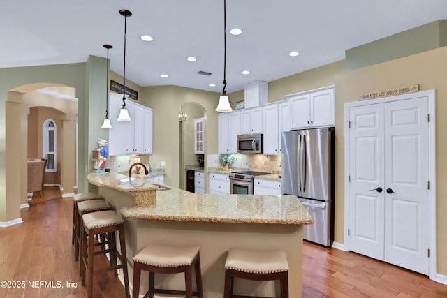 kitchen featuring kitchen peninsula, sink, pendant lighting, and stainless steel appliances