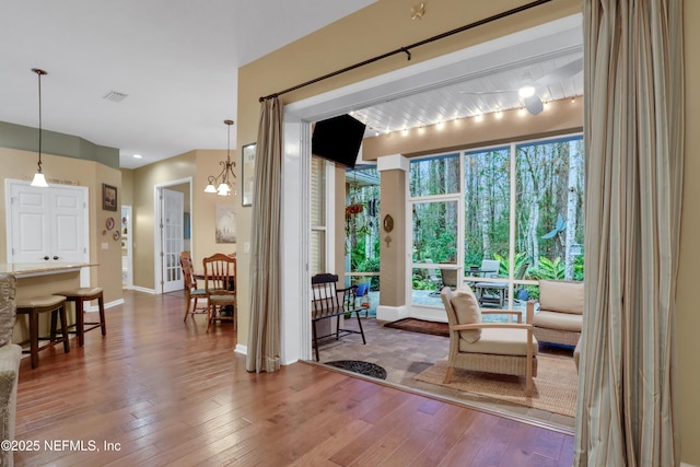 interior space with hardwood / wood-style flooring and a chandelier