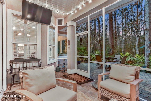 sunroom featuring track lighting