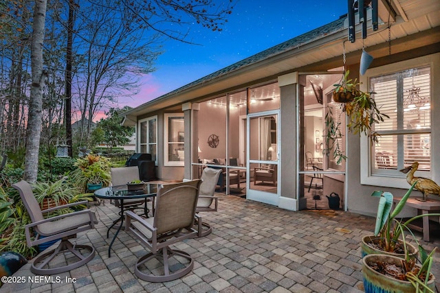 patio terrace at dusk featuring area for grilling