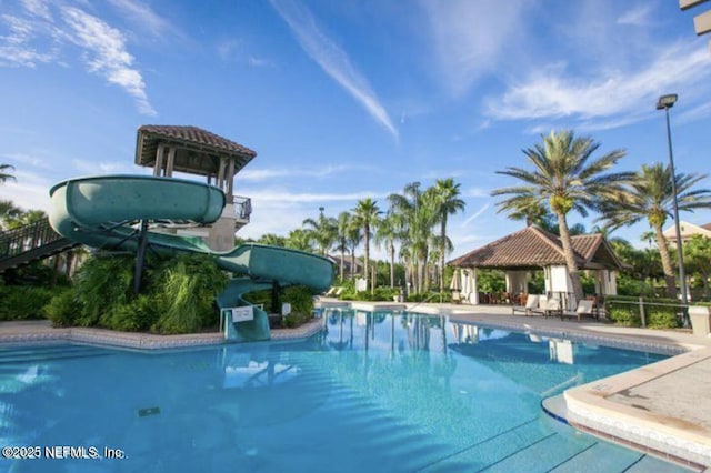 view of pool with a gazebo and a water slide