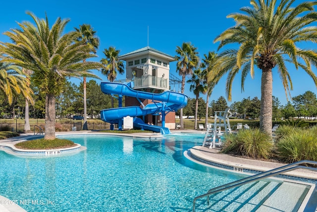 view of swimming pool with a water slide