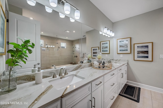 bathroom with tile patterned flooring, a shower with shower door, and vanity