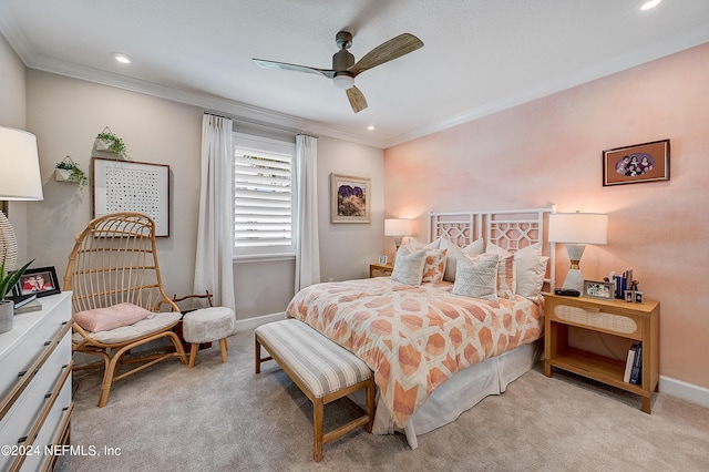 bedroom with ceiling fan, light colored carpet, and crown molding