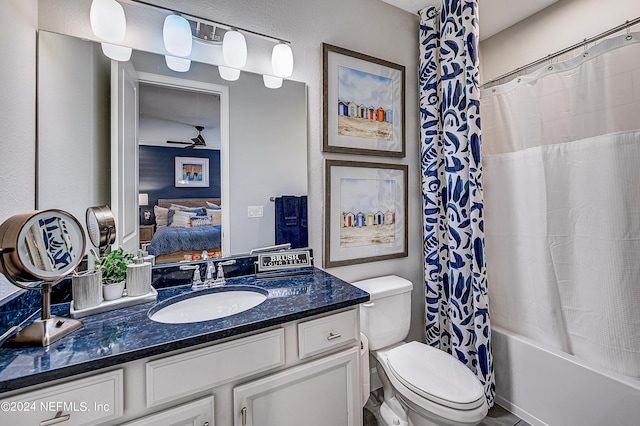 full bathroom featuring vanity, toilet, ceiling fan, and shower / bath combo with shower curtain