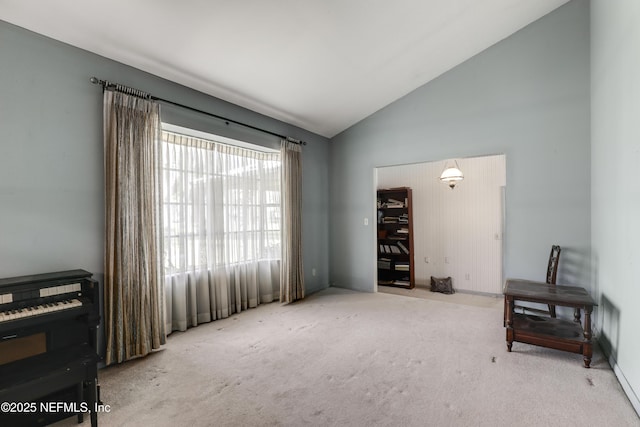 sitting room featuring light carpet and high vaulted ceiling